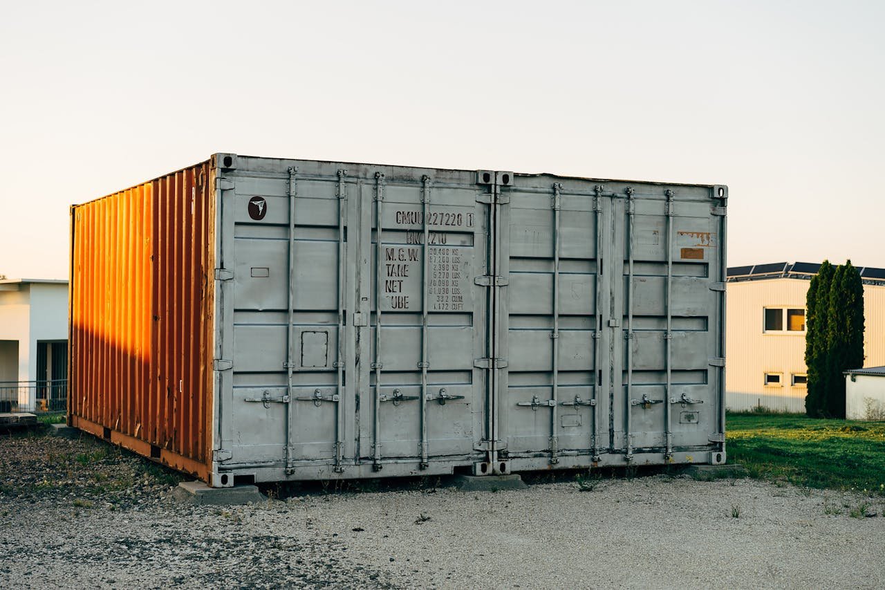 Outdoor view of a metal shipping container at a storage facility.